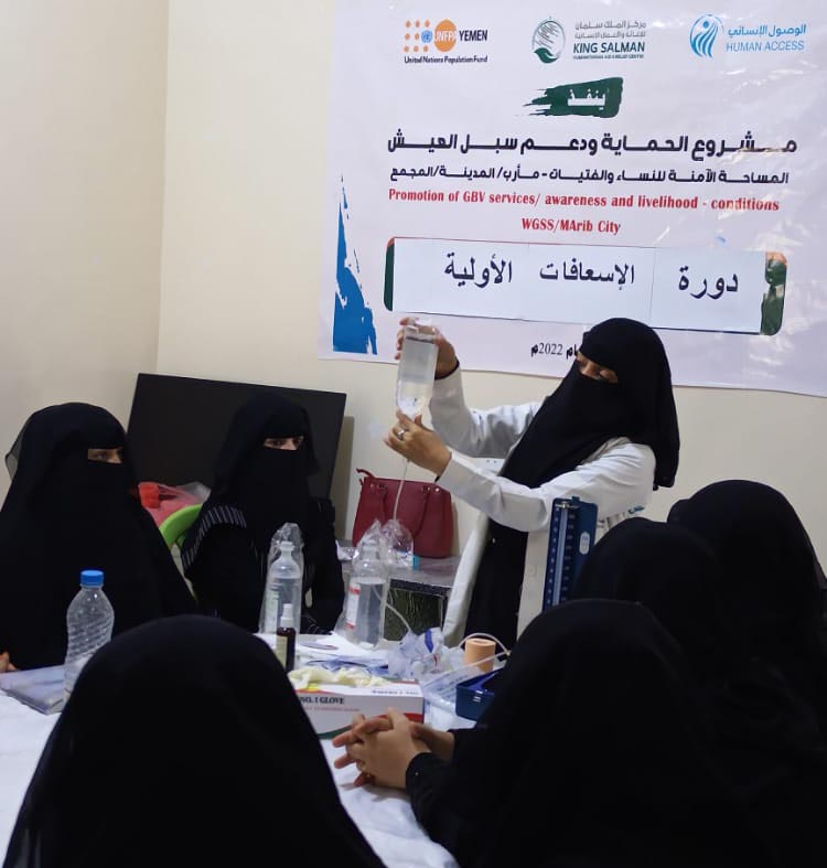 In the presence of a number of women and girls, First-aid training